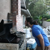 Angelo spits alcohol onto the grill