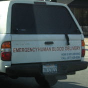An awful picture of an "Emergency Human Blood Delivery" car.