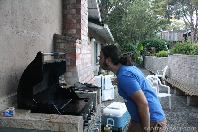 Angelo spits alcohol onto the grill