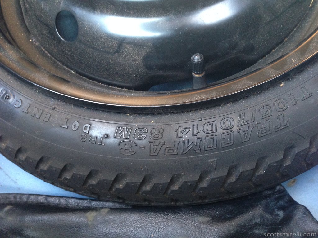 This spare tire is over twenty-one years old.